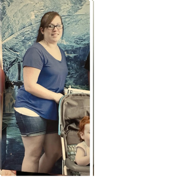Woman standing next to a stroller with a child inside.
