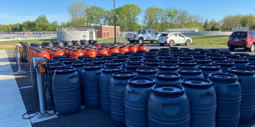 Dozens of rain barrels waiting to be picked up from the DeKalb County Rain Barrel sale. 