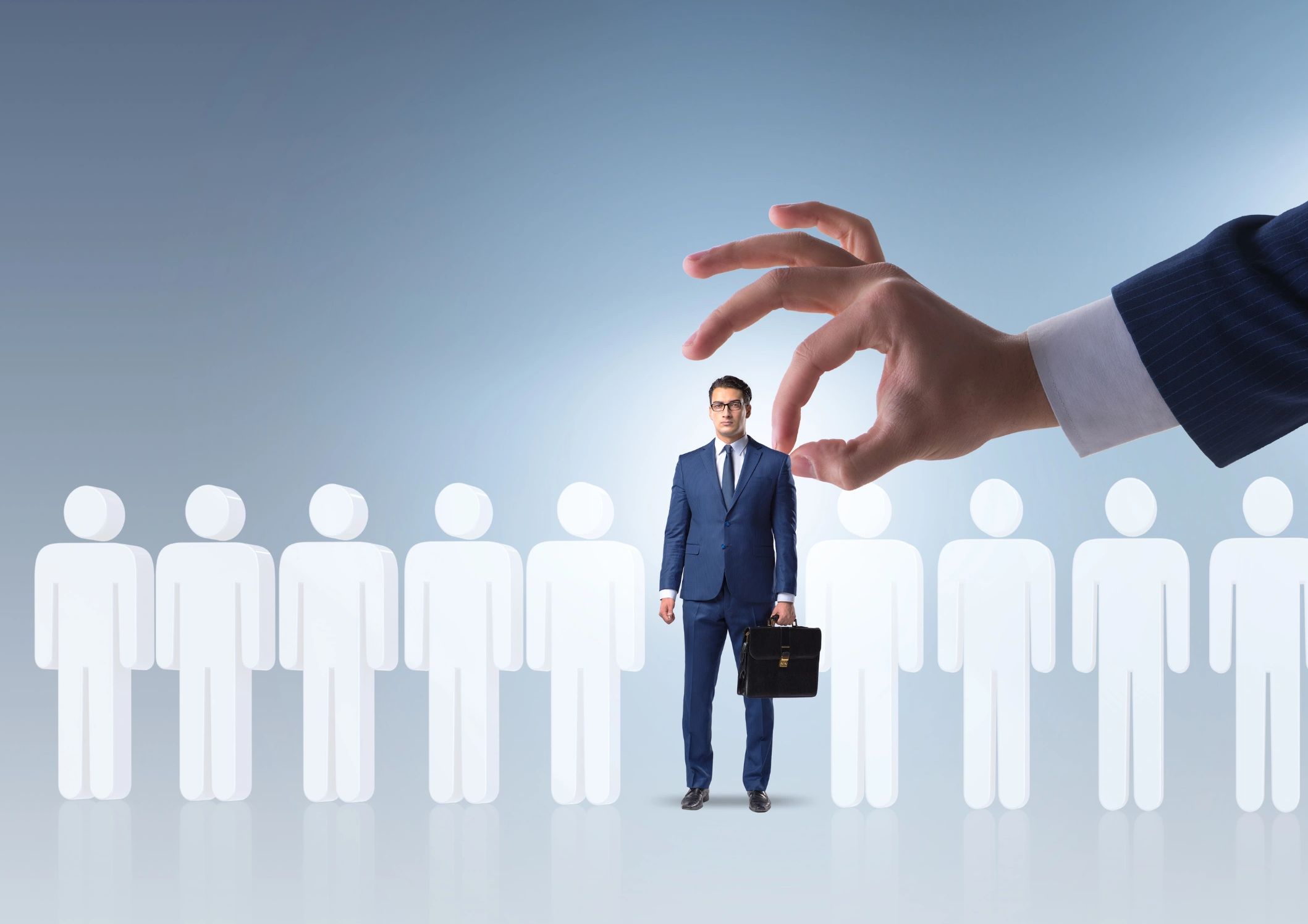 A giant hand selecting a businessman from a line of icons, symbolizing choice or recruitment.