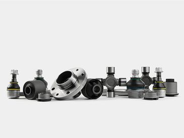 A lineup of various automotive suspension parts on a white background.