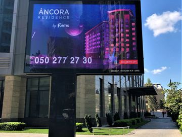 Pillar-mounted LED display for commercial advertising outdoors. 