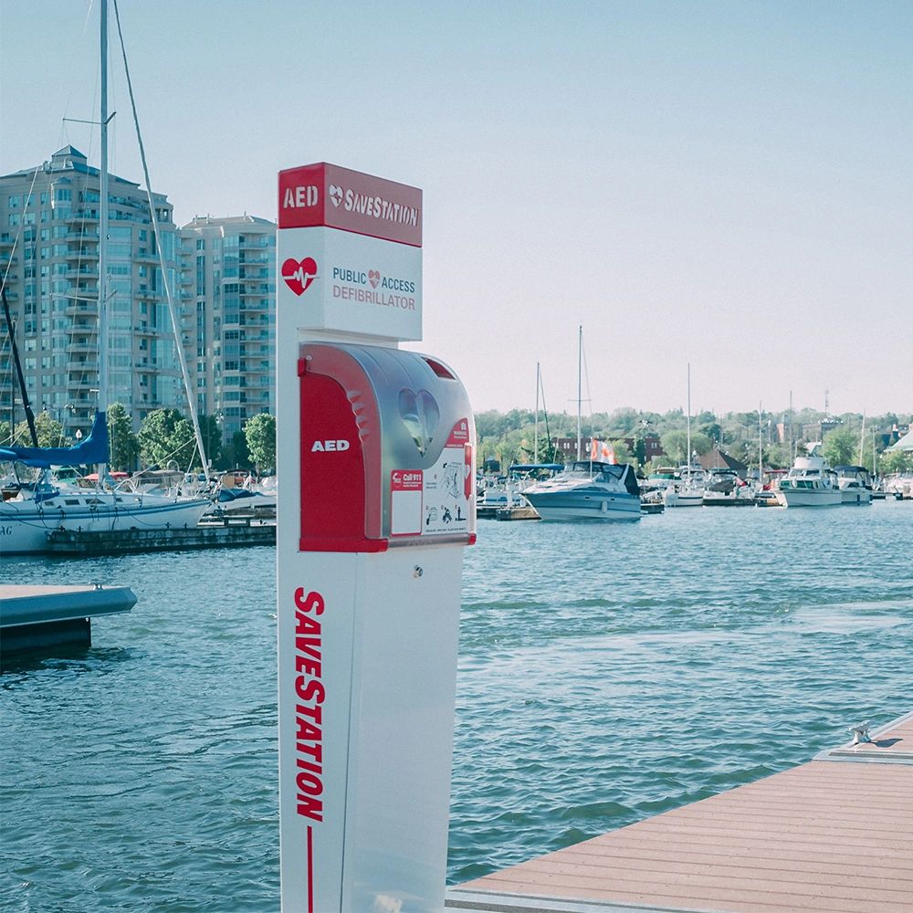 AED defibrillator station at a marina dock.