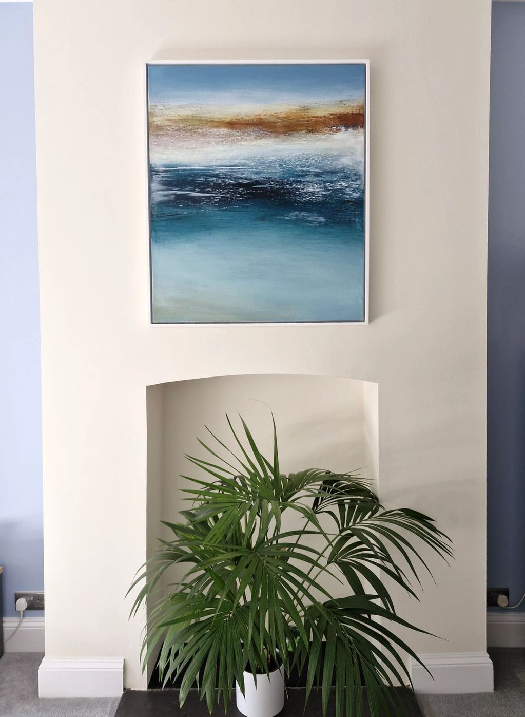 A beautiful painting of the colours of the sea set in home above the open fireplace