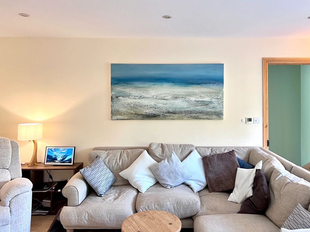 a beautiful large painting of the essence of the sea, blue sky and energy of the waves in a living r