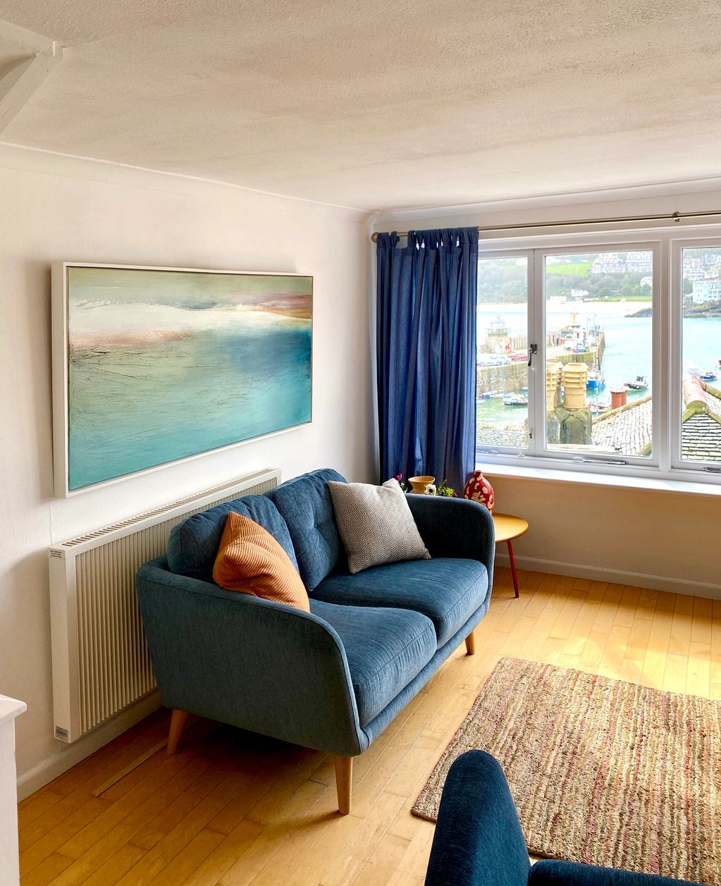 a large painting on canvas about the sea in a coastal livingroom