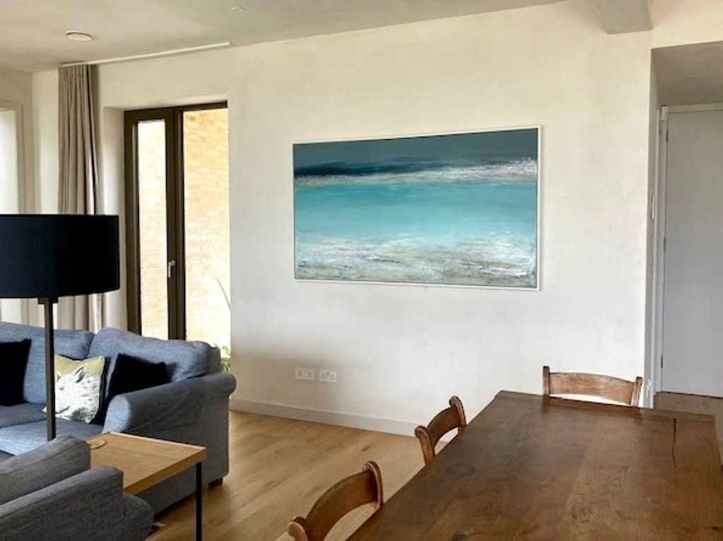 A large painting of the sea, St Ives unique colour palette, aquamarine sea and a moody grey sky