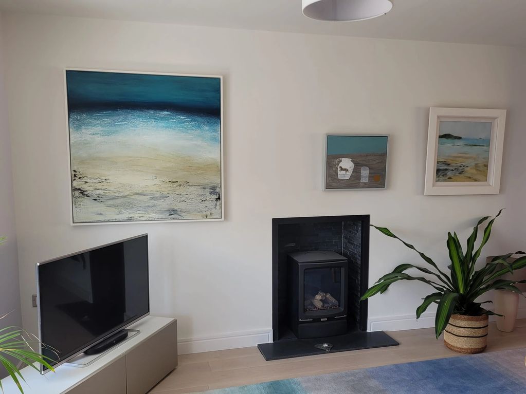 a sea inspired painting in a beautiful living room setting 