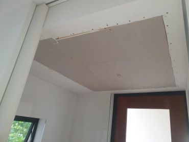 Unfinished drywall ceiling installation.