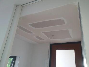 Ceiling with patches and unfinished drywall.