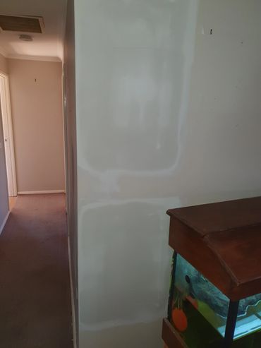 Indoor corner with hallway, wall, and fish tank.