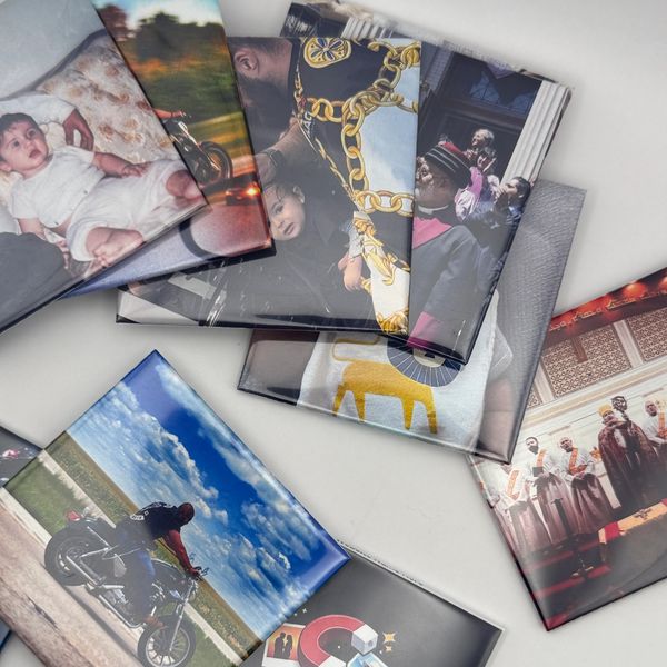 A collection of personalized photo magnets arranged on a white surface.