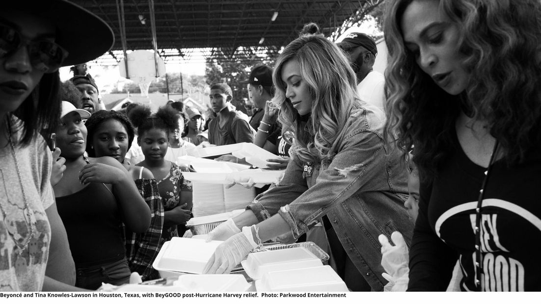 Beyonce and Tina Knowles-Lawson handing lunches to people after Hurricane Harvey