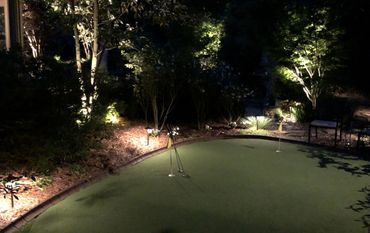 Downlights and tree lights all help illuminate this putting green.