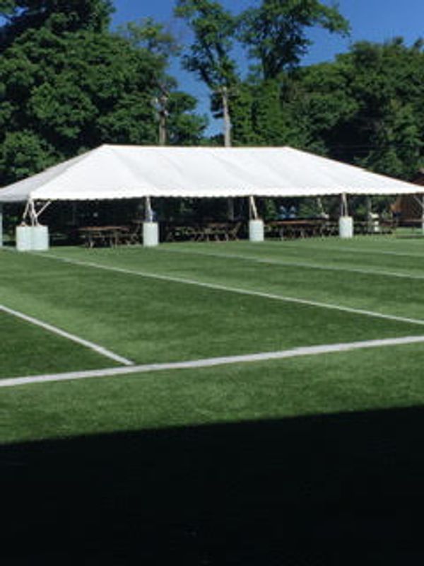 Sports event with table, chairs, and tent setup