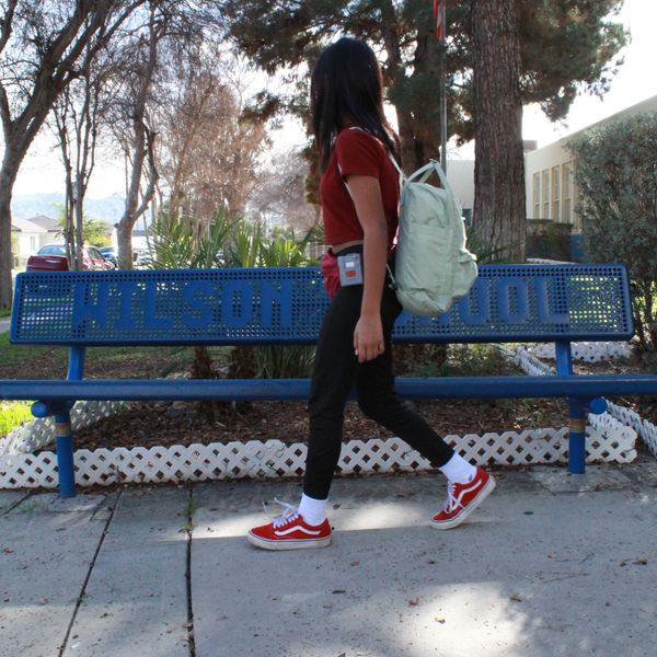Anabel Aguilar walking near Woodrow Wilson Elementary School bench in Colton, CA.