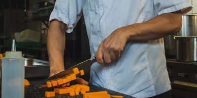 A person chopping carrots