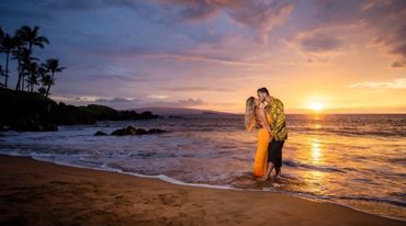 Couple kissing during Maui sunset.