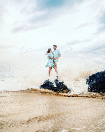 Couple standing at Lava rock in Maui.