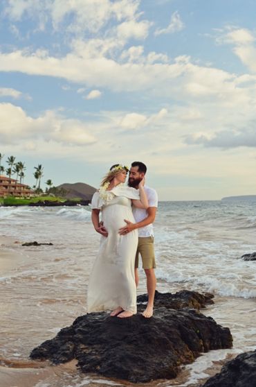 Pregnant woman and men standing at Lava rock in Wailea.