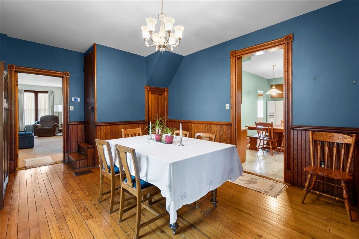 Cozy dining room with blue walls and wooden furniture.