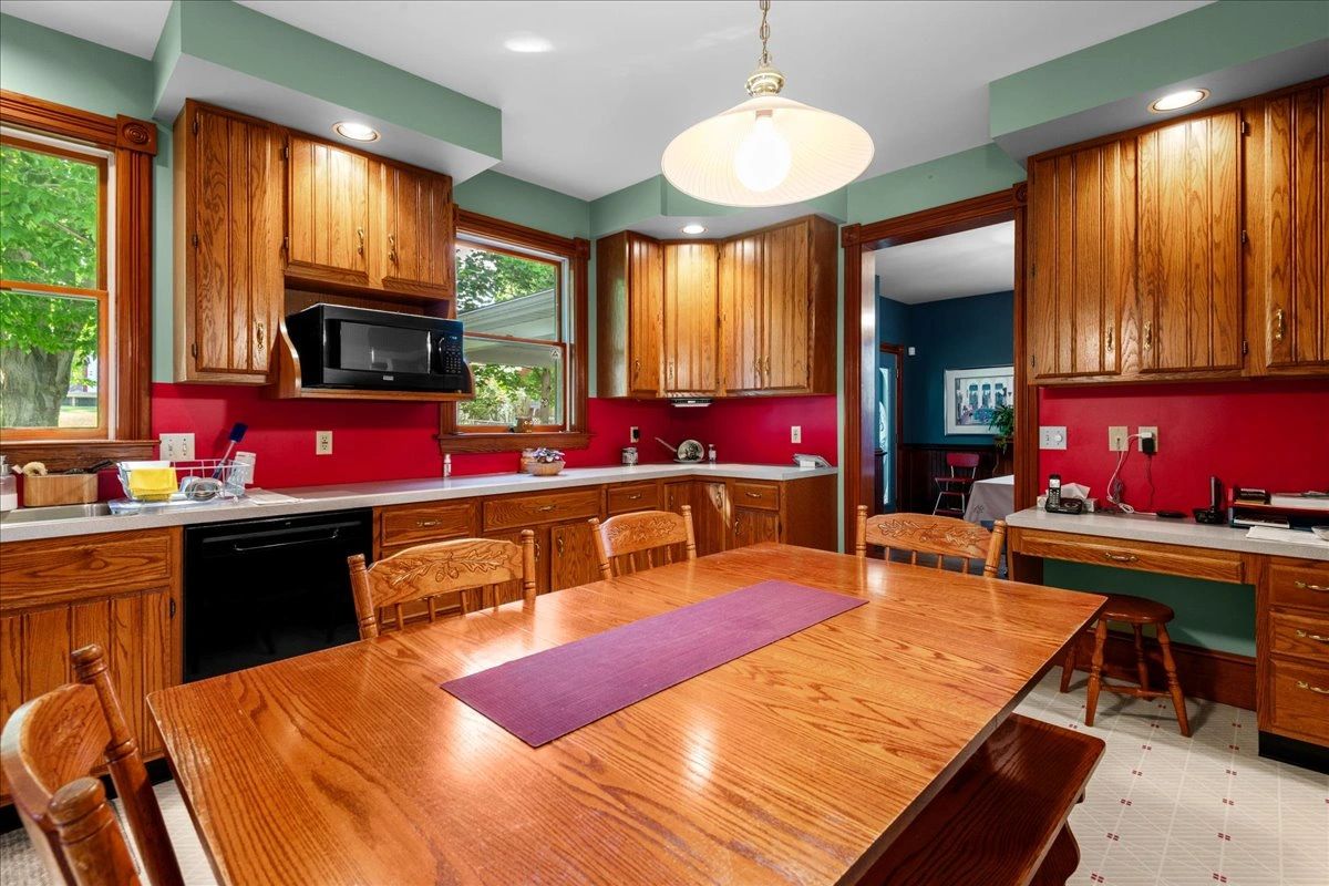 Cozy kitchen with wooden cabinets and a large dining table.