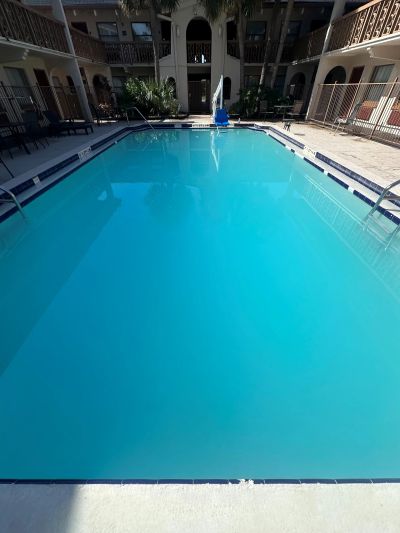 Clear blue swimming pool in a courtyard.