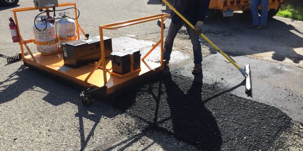 Asphalt repair truck parking lot trailer drop site