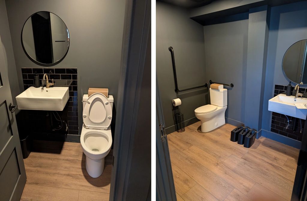 Modern bathroom with wooden floor, white toilet, and sink.