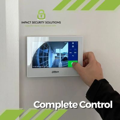 A hand controlling a intercom monitor from Impact Security Solutions.