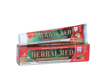 Tube and box of Herbal Red toothpaste with natural herb seed.