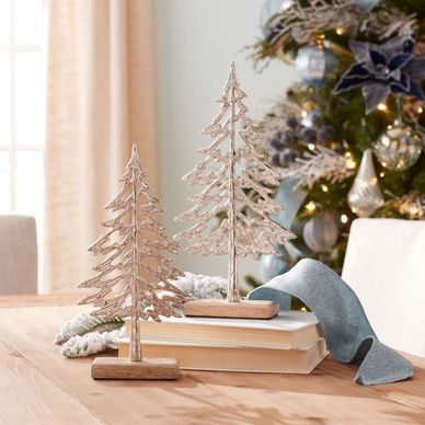Premium tabletop trees and matching festive holiday garland adding the finishing touches to a decora