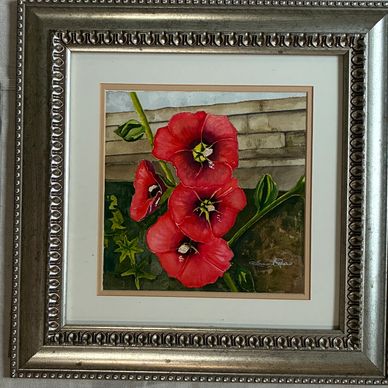 Framed painting of red flowers with green leaves.