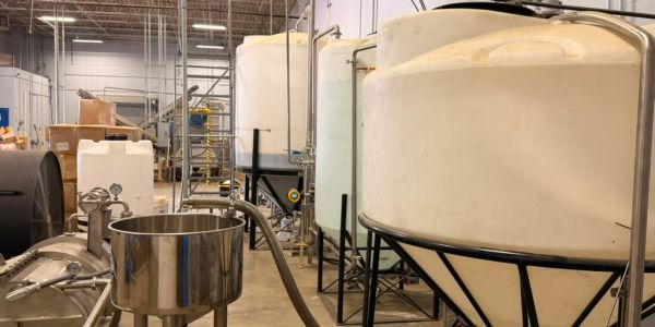 Large industrial tanks inside a warehouse.