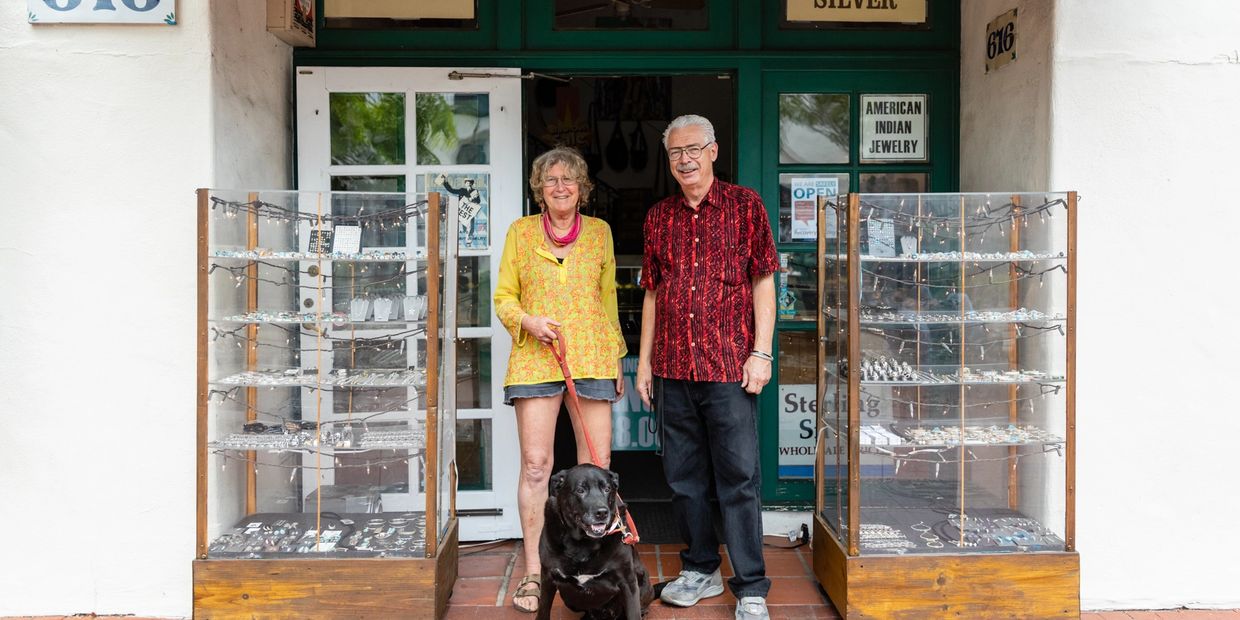 an elderly man and woman with a dog 