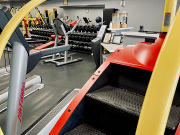 Gym equipment with weights and machines.