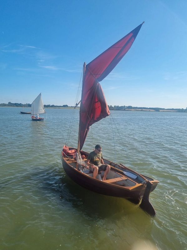 Atlas cruising sailing dinghy on river alde