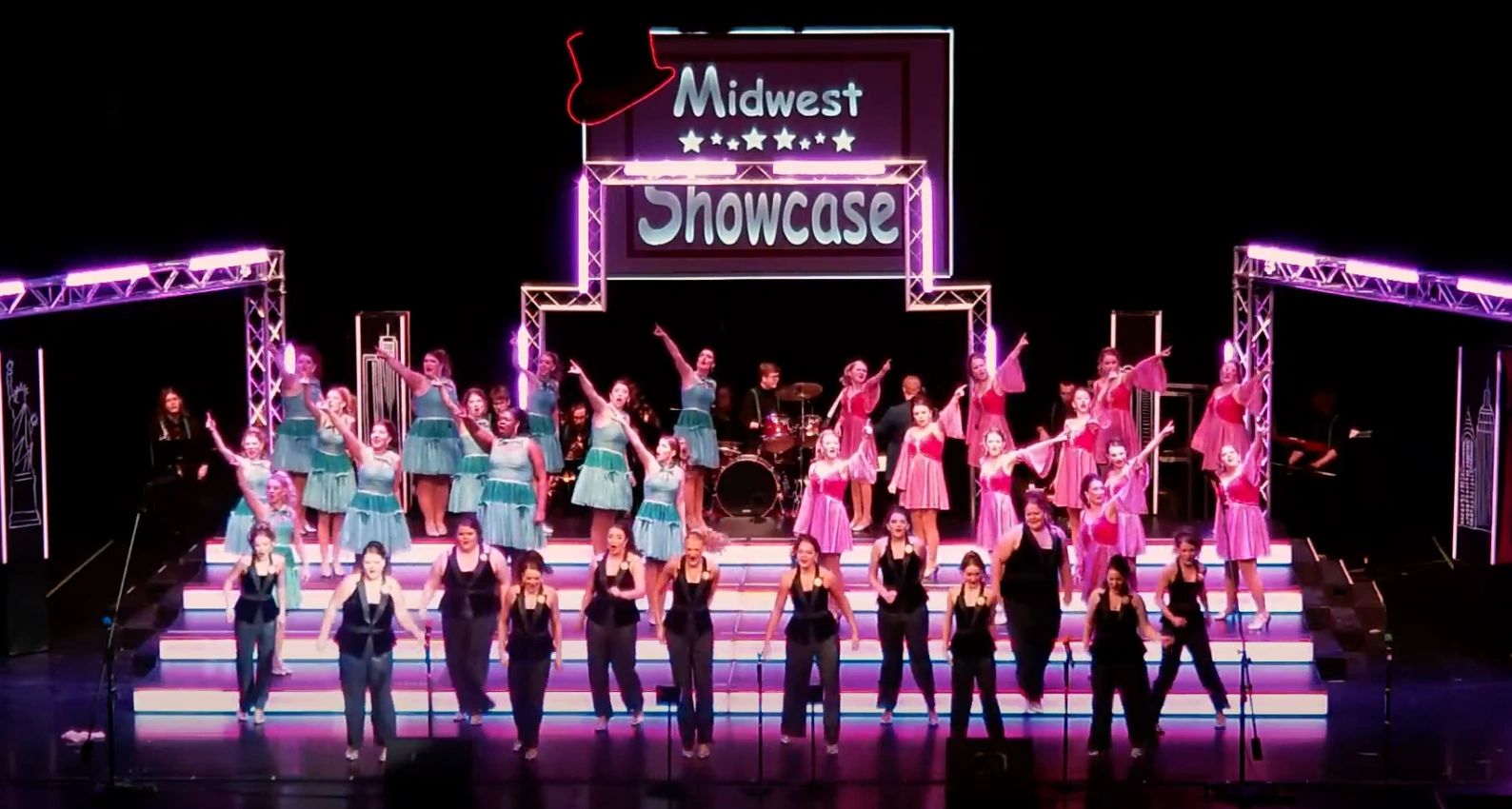 Performers singing and dancing on stage at Midwest Showcase.