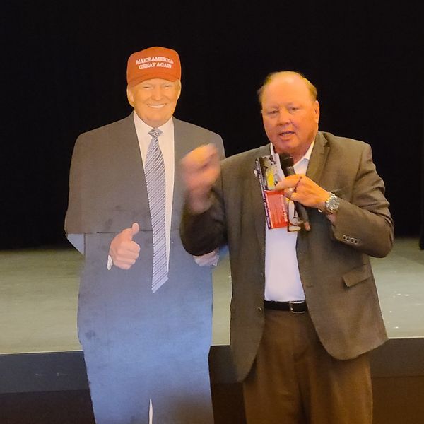 County Assessor Doug Wolf standing with a cutout of Donald Trump