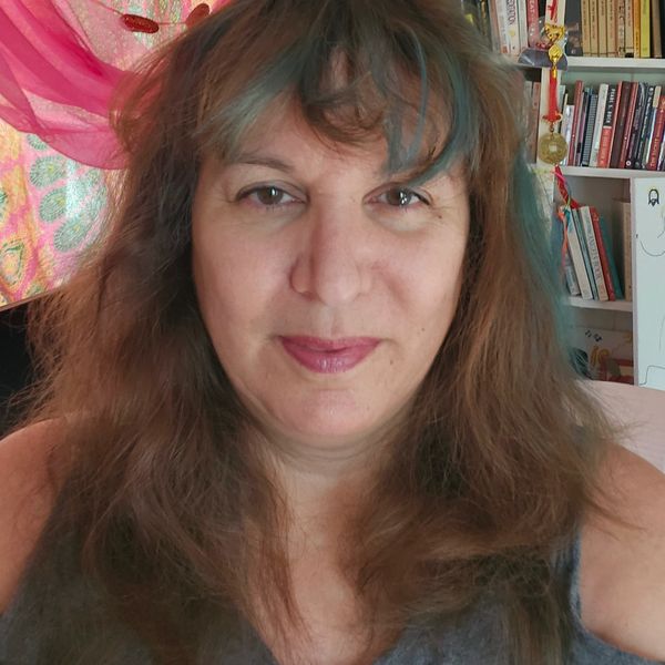 Woman with long hair smiling indoors