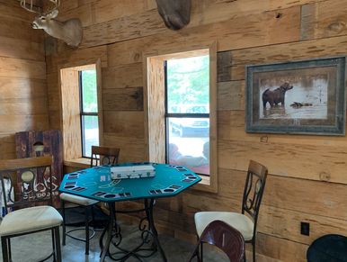 Cozy rustic room with card table and animal-themed decor.