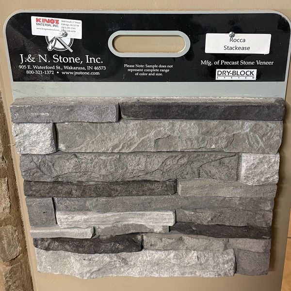 Sample board of Rocca stackease precast stone veneer in various gray tones.