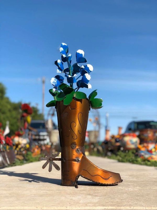 Iron art and sculptures with blue bonnets.