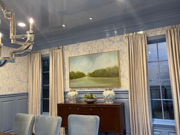 Elegant dining room with soft blue tones and nature-inspired decor.