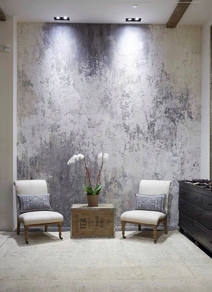 Cozy living room with pink velvet sofa and stencil art wallpaper.