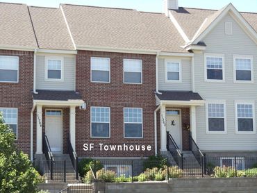 Two-story townhouses with brick and siding exteriors.