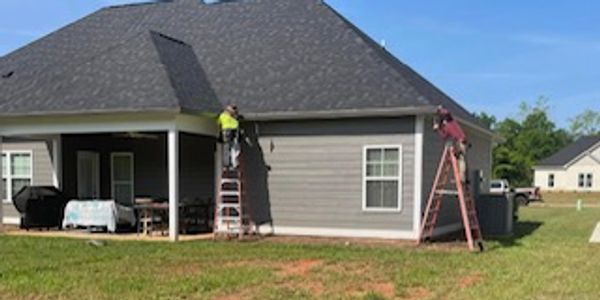 Our crew doing seamless gutter installation for homes in Georgia and Florida