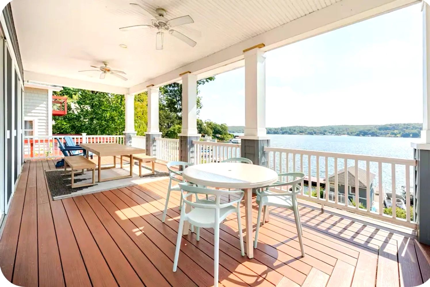 Spacious lakeside deck with dining and stunning lake views.