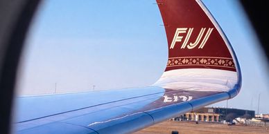 Airplane wing with FIJI branding.