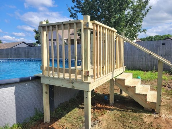 Small, custom pool deck with railing. 