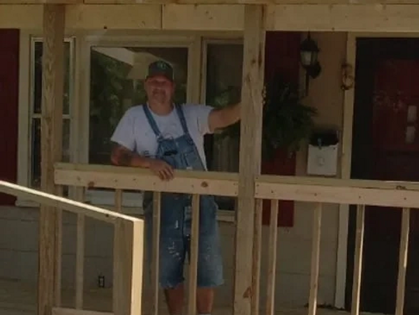 Billy standing on the custom patio construction in progress.